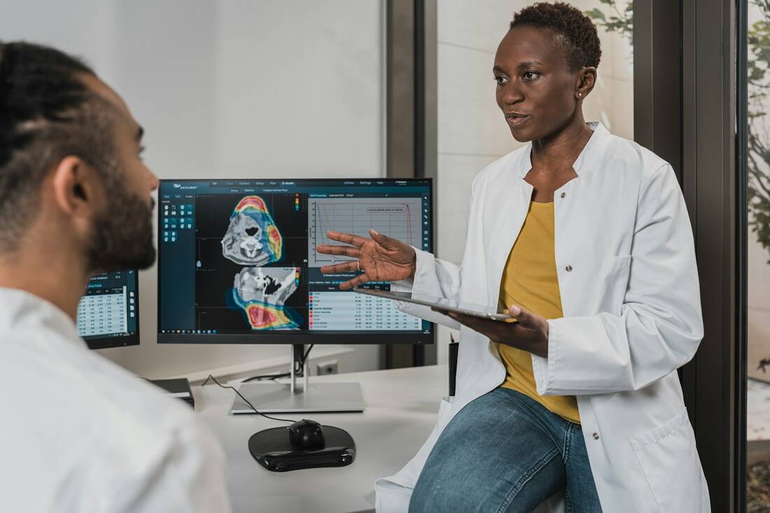 Doctors reviewing a patient's scan on a monitor in a modern clinic